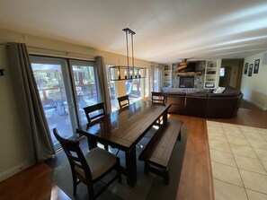 Relax in this inviting living area with a dining table, comfortable seating, and a fireplace.