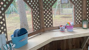 A wooden snack bar with a menu board, a blue dish rack, and a lantern. - Lake House 100 yards off snowmobile trail #8.  (Michigamme)