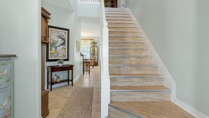 A staircase with wooden steps and white railings, leading to a second floor. - Waterfront! Docks available for rent and extra parking lot and ice machine (Homosassa)