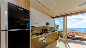 A modern kitchen with a view of the ocean. - DREAM CONDO: OCEAN VIEWS & ONLY STEPS FROM THE BEACH (Puerto Vallarta)