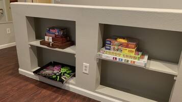 Bookshelf unit with storage for board games and a drawer.