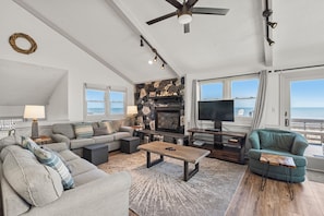 A living room with a fireplace, television, and seating area.