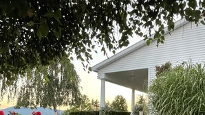 A stone pathway leading to a covered porch with potted plants and a view of a mountain. - Gentleman’s Farm Mountain Views Gourmet Kitchen Fire Pit Hike Ski Sleep 10 Pets! (Oak Hill)