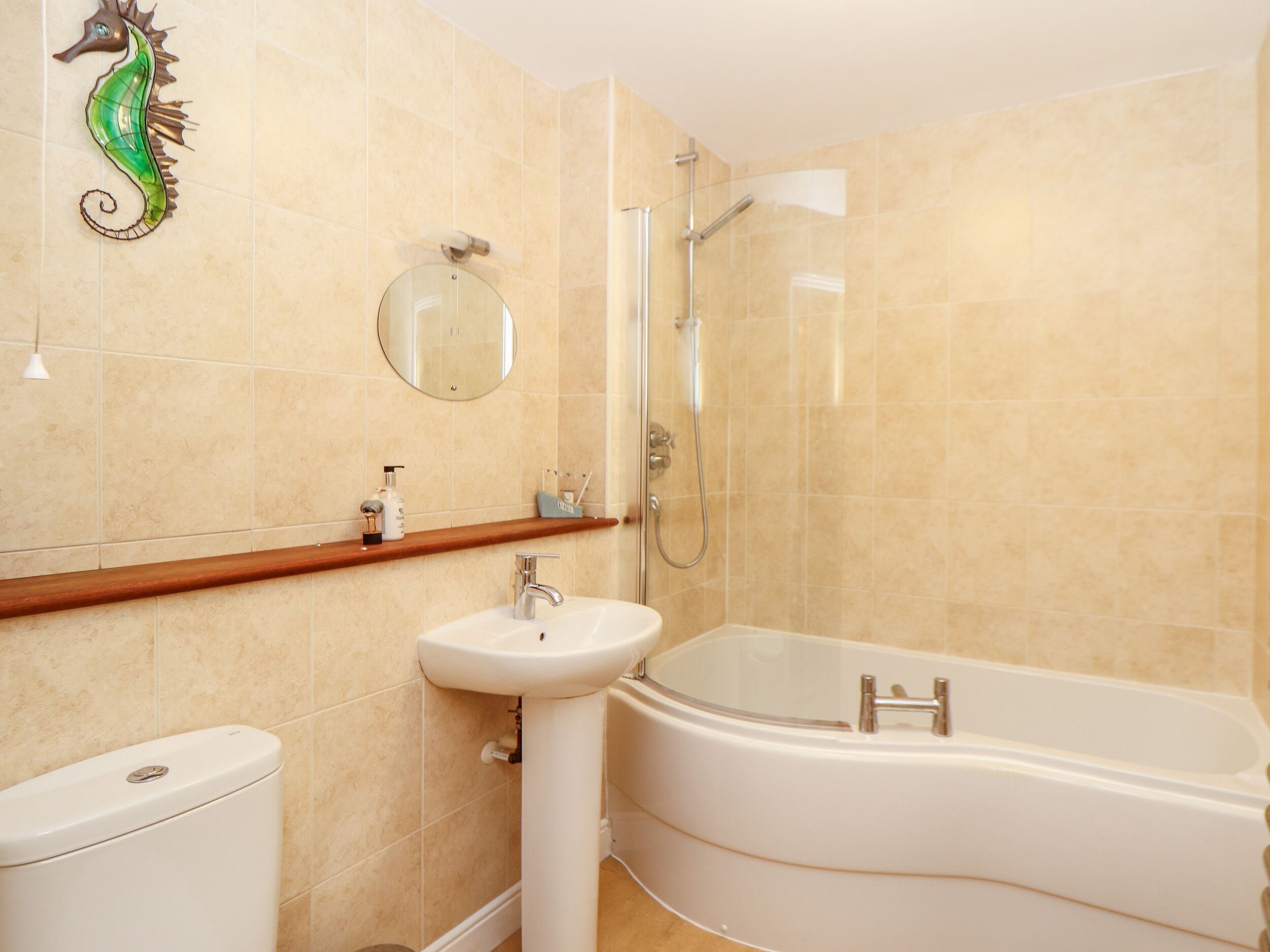 A bathroom with a toilet, sink, and bathtub.