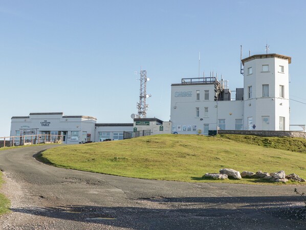 A building with multiple white structures, including a prominent tower with antennas.