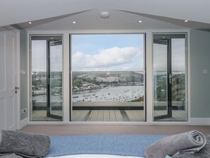 A balcony with a view of a marina and hills. - Moorings (Dartmouth)