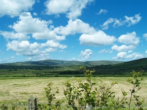 A rural landscape with rolling hills, a clear sky, and a fence in the foreground. - Sarnau (Clynderwen)