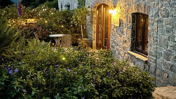 A stone building with a door, a window, and a sign that reads 'Stable.'