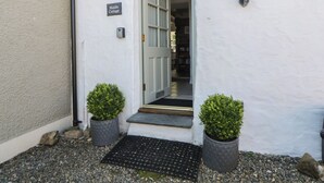 A white building with a sign reading 'Middle Cottage.' - Middle Cottage (Newport)