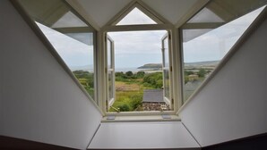 A skylight with a view of a rural landscape, including fields and a distant hill. - Gwelfor, Newport (Fishguard)