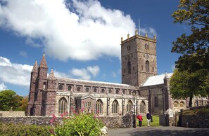 A historic stone building with a prominent tower and arched windows. - Greenfields (Haverfordwest)