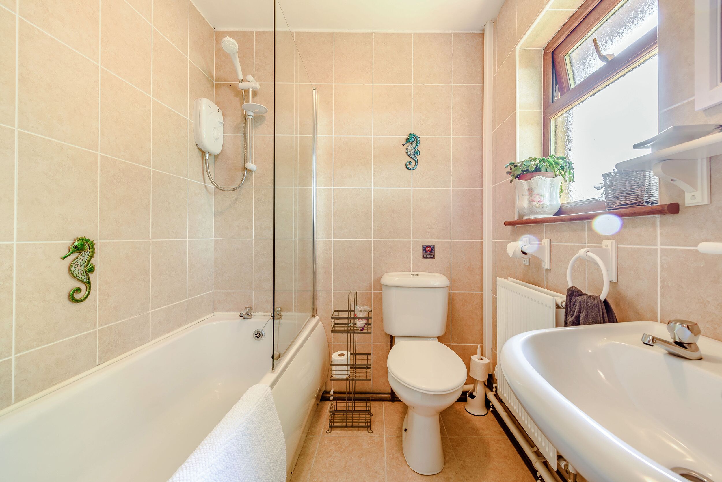 A bathroom with a bathtub, toilet, and shower.