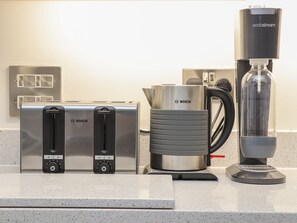 A kitchen with a Bosch toaster, a Bosch coffee maker, and a kettle. - Idlewild, 2 Wheal Turnavore (St. Agnes)