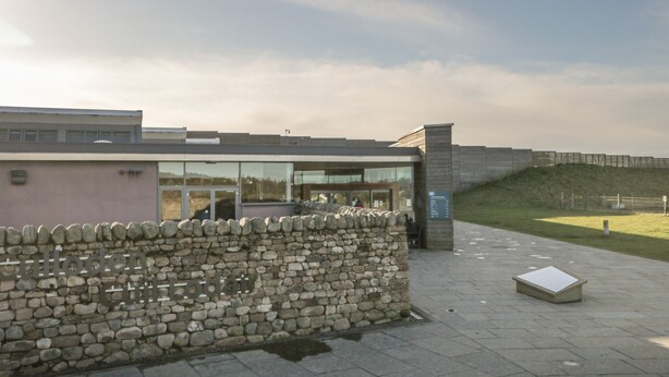 A modern building with a stone wall and glass entrance. - The Nook (Inverness)