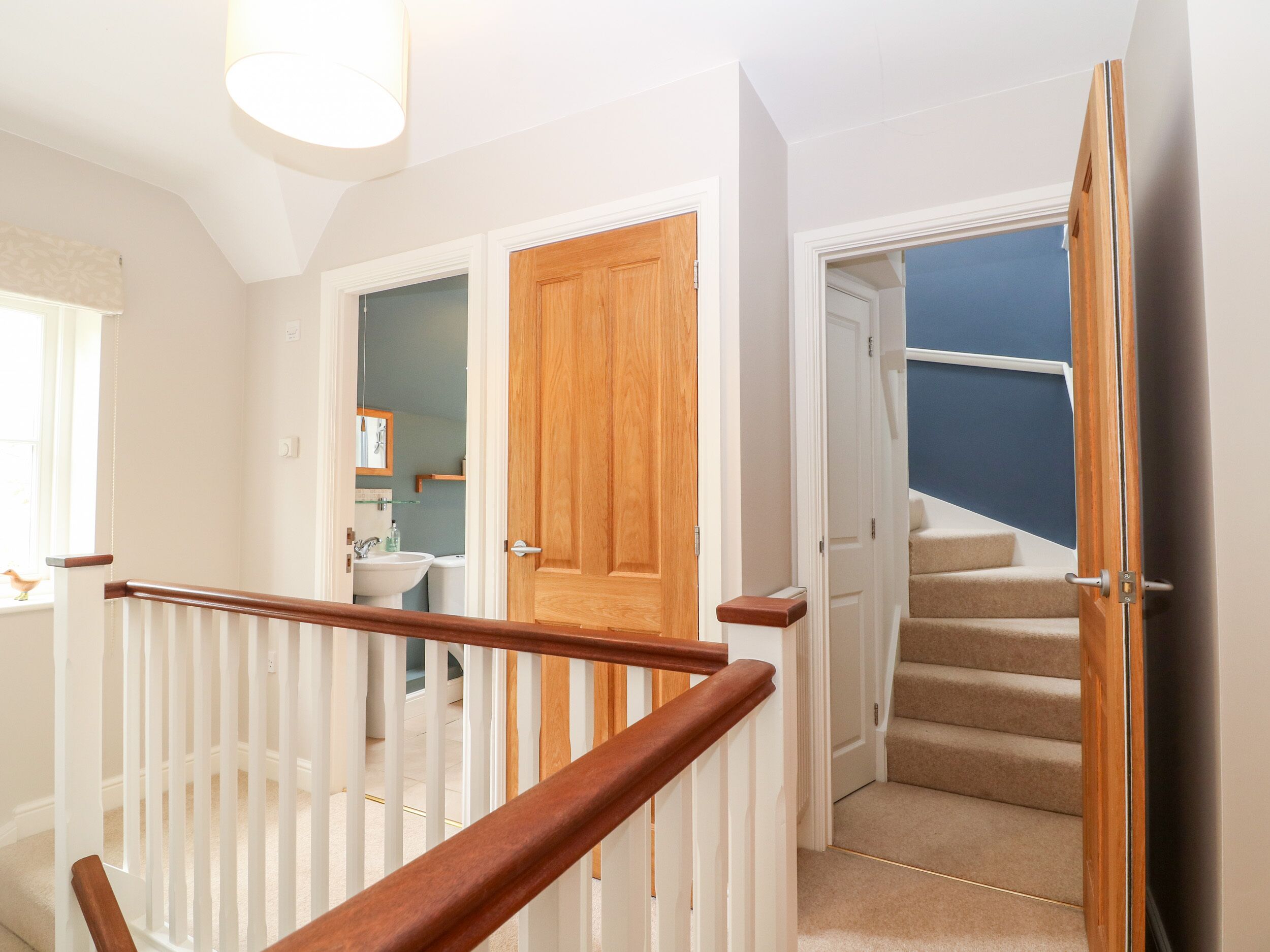 A staircase leading to a bedroom with a view of the sky.