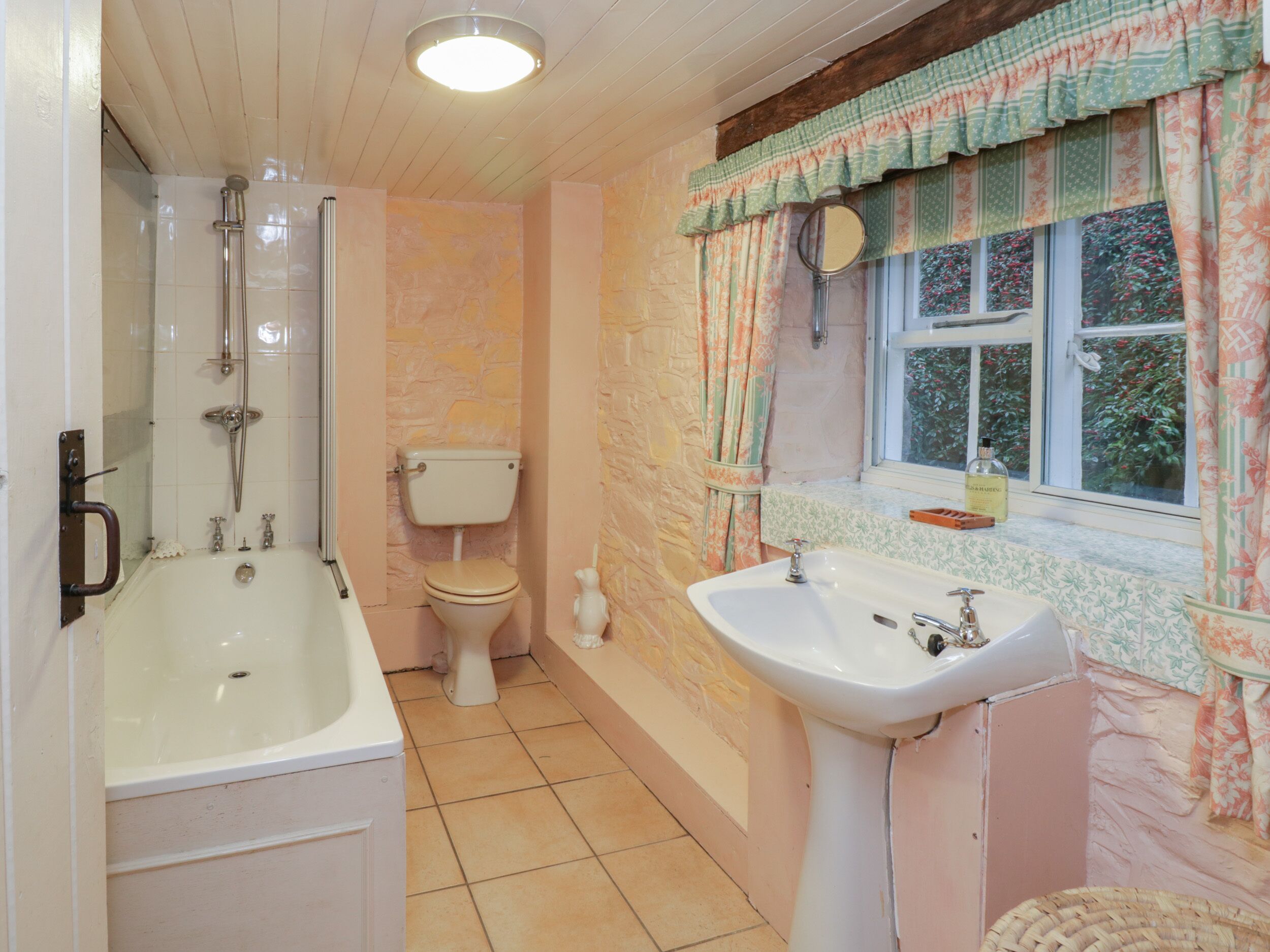 A bathroom with a bathtub, toilet, and sink.