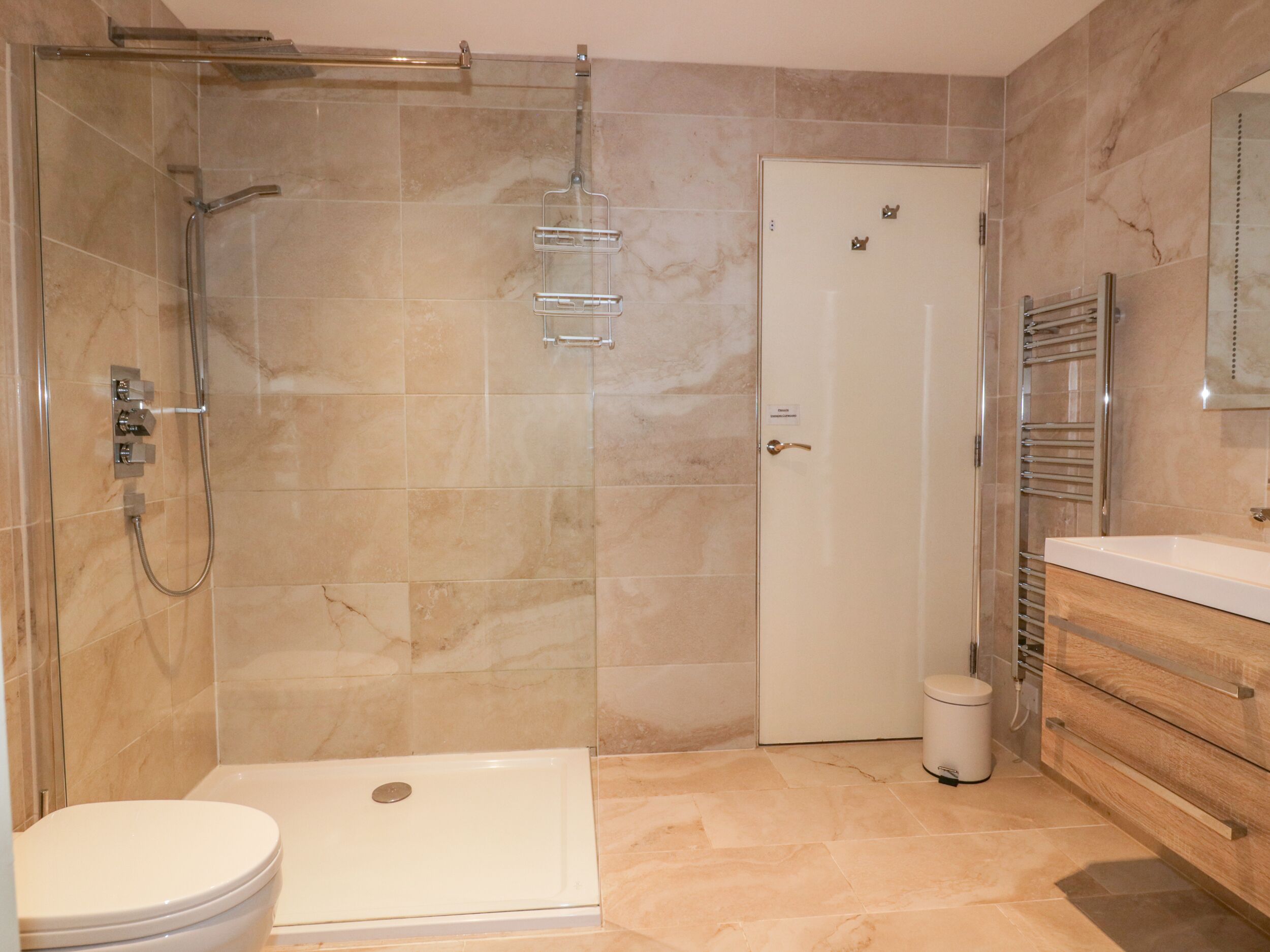 A bathroom with a shower, toilet, and vanity.