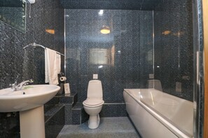 Un baño moderno con lavamanos, inodoro y bañera.