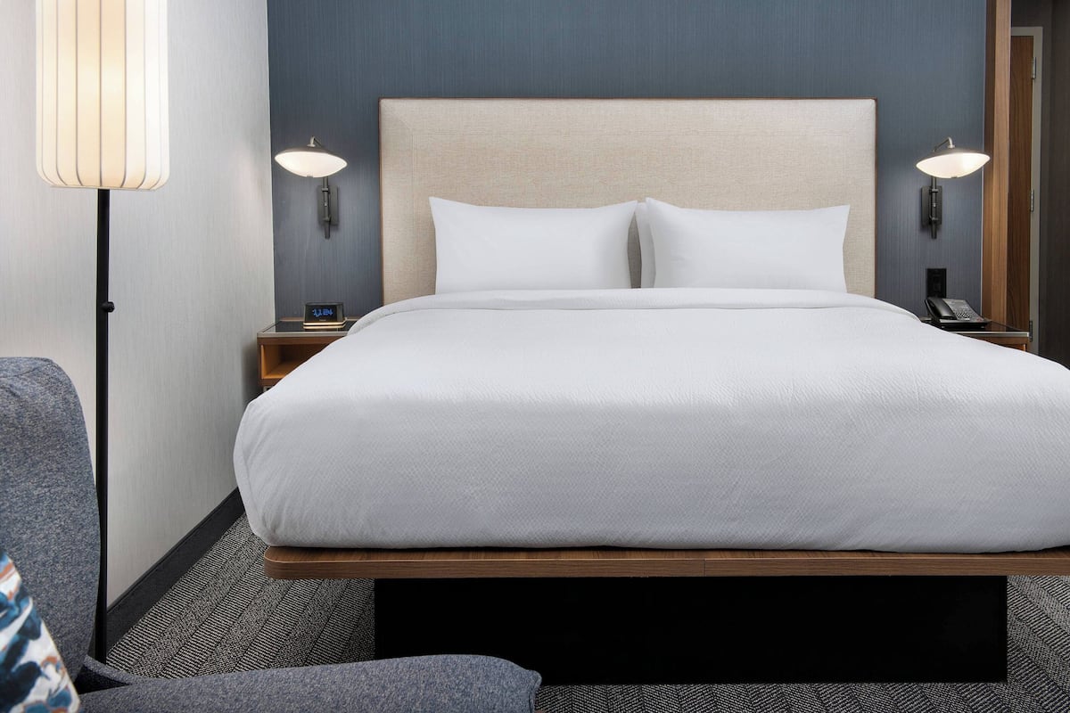 Premium bedding, desk, laptop workspace, iron/ironing board