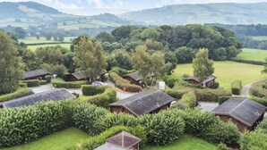 A rural village with traditional cottages, surrounded by lush greenery and rolling hills. - Valley View (Rhayader)