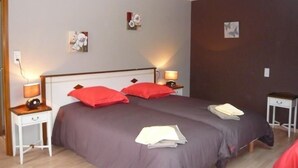 A bedroom with a bed, two nightstands, and a ceiling light.