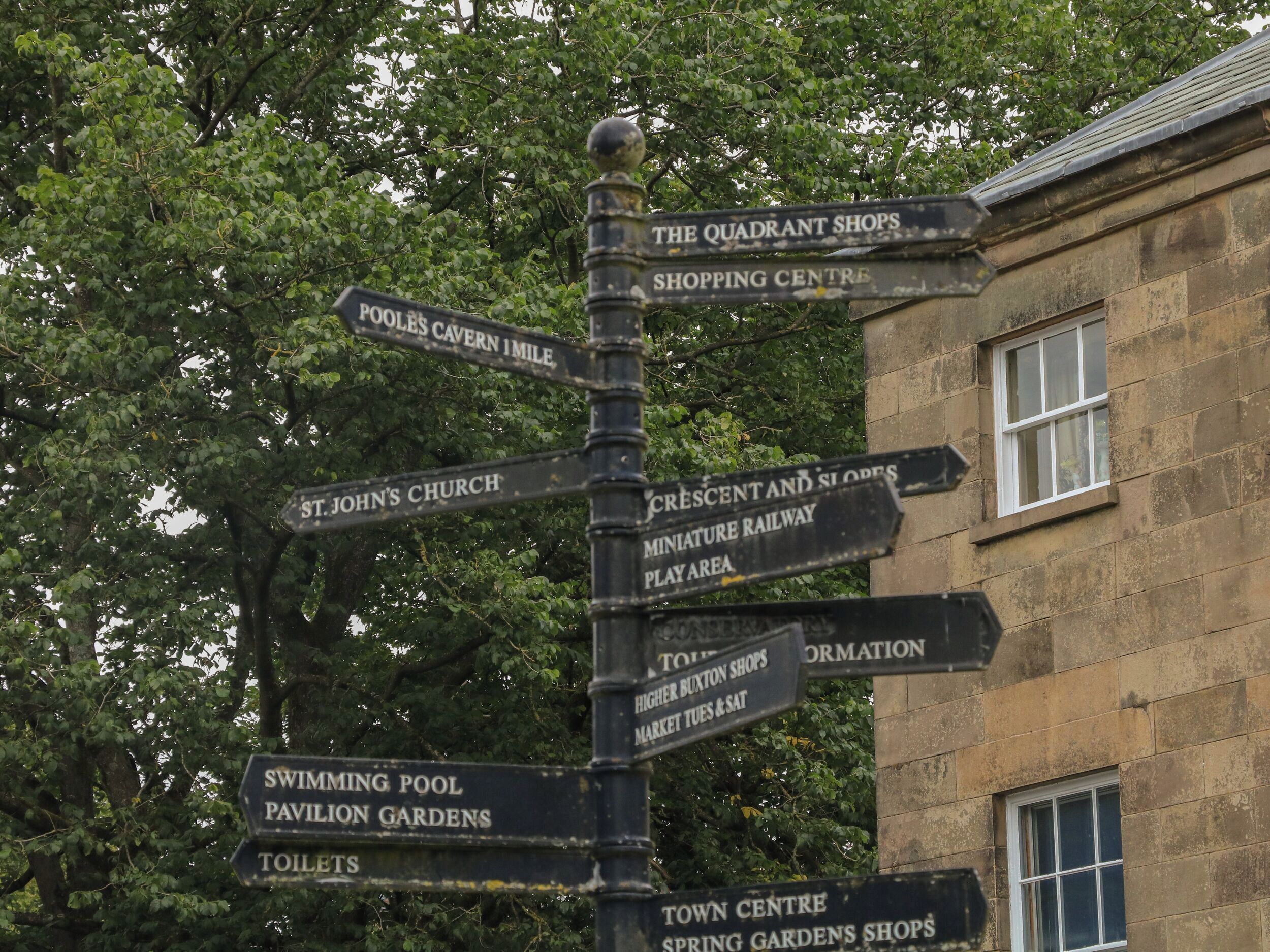 A directional signpost with multiple directions to local attractions and facilities.