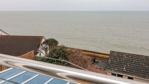 A coastal view with a house and a sea in the background. - St Julien (Dawlish)