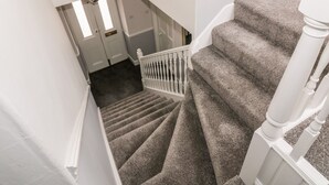 A staircase with carpeted steps and white railings. - Ivy Bank (Thornhill)