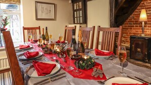 A dining table set for a meal with wine glasses, plates, and cutlery. - Bakehouse Farm (Princes Risborough)