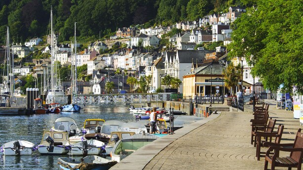 A waterfront promenade with boats docked, a restaurant, and residential buildings in the background. - 2 Embankment House (Dartmouth)