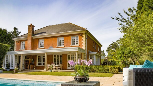 A two-story house with a swimming pool, outdoor furniture, and a garden. - Gleneagles (Ascot)