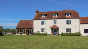 A large, two-story building with a red-tiled roof and a central entrance. - Groomes Country House (Bordon)