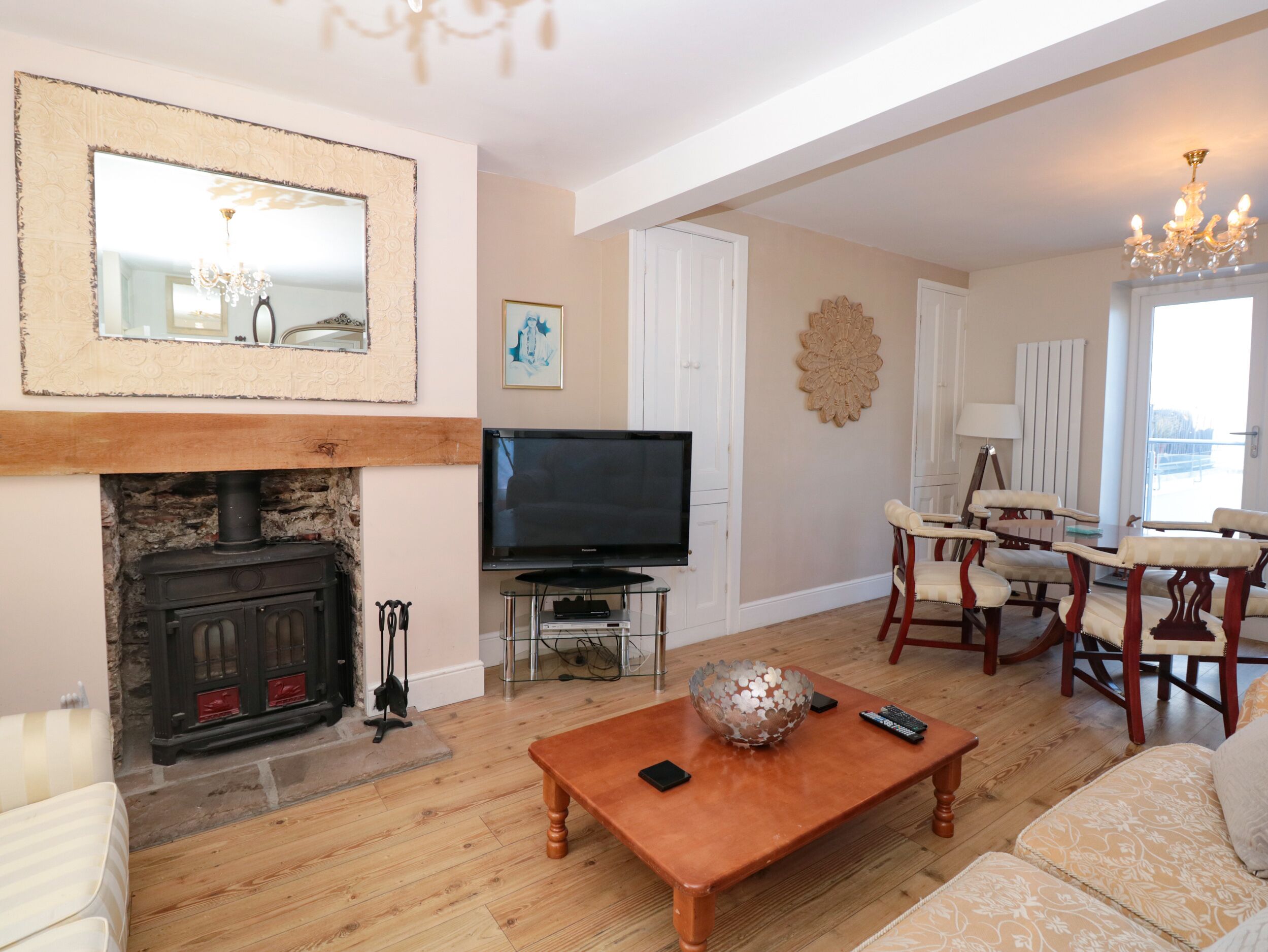 A living room with a fireplace, television, and seating area.