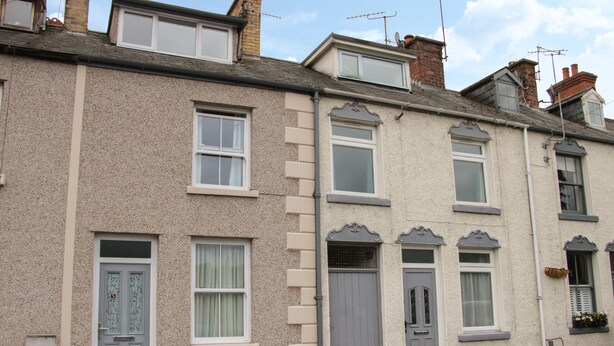 A row of terraced houses with distinct architectural features, including bay windows and decorative moldings. - Whitewater Cottage (Llangollen)