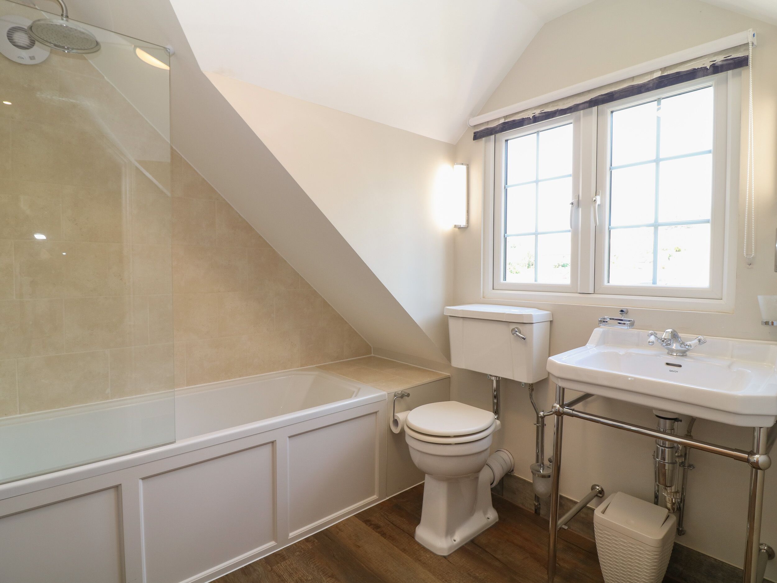 A bathroom with a bathtub, toilet, and sink.
