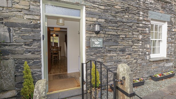 A stone building with a sign reading "Holly Tree Cottage." - Holly Tree Cottage (Coniston)