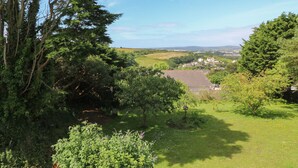A rural landscape with a house surrounded by trees and open fields. - Little Valley View (Hayle)