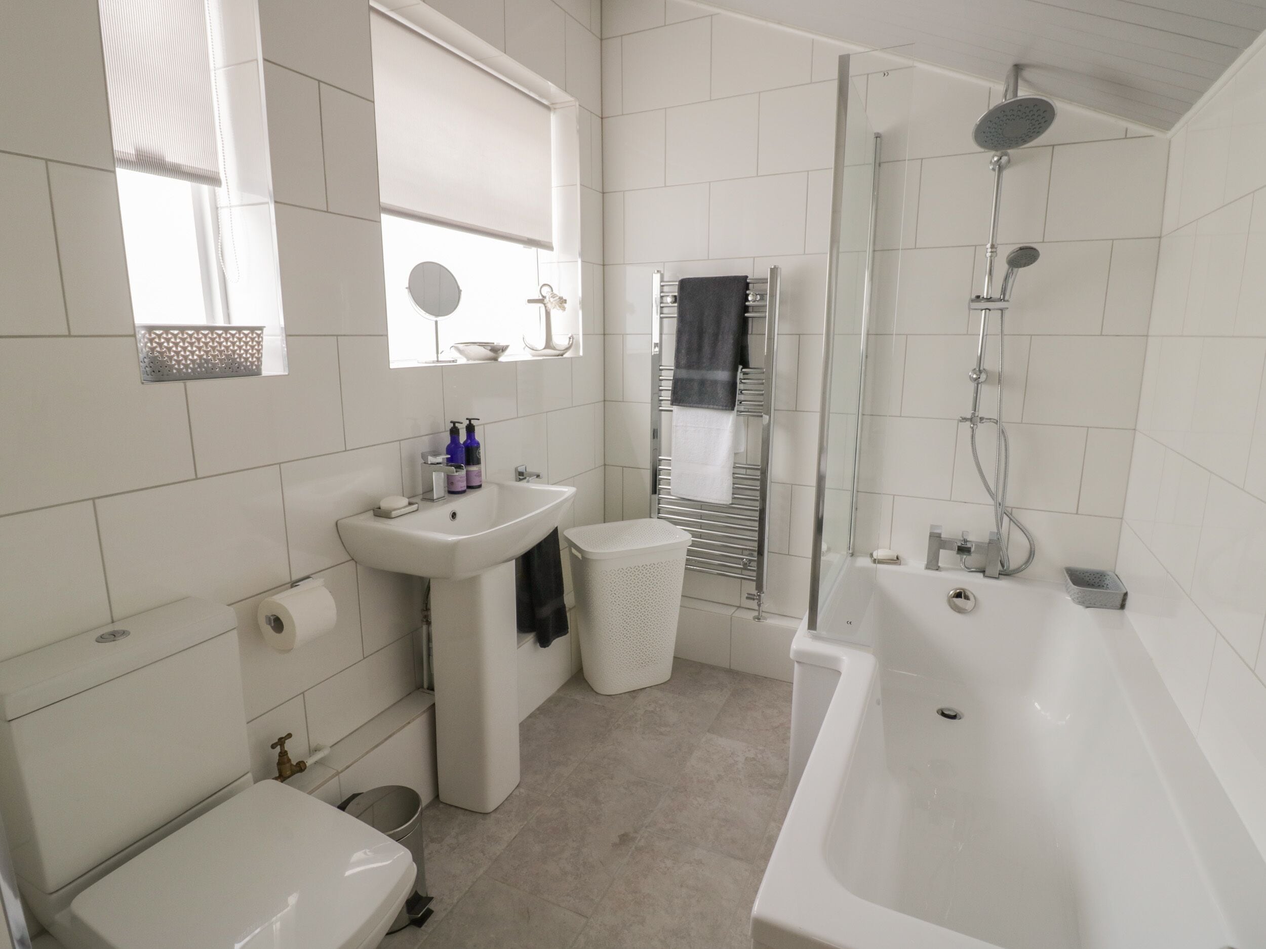 A modern bathroom with a toilet, sink, and bathtub.