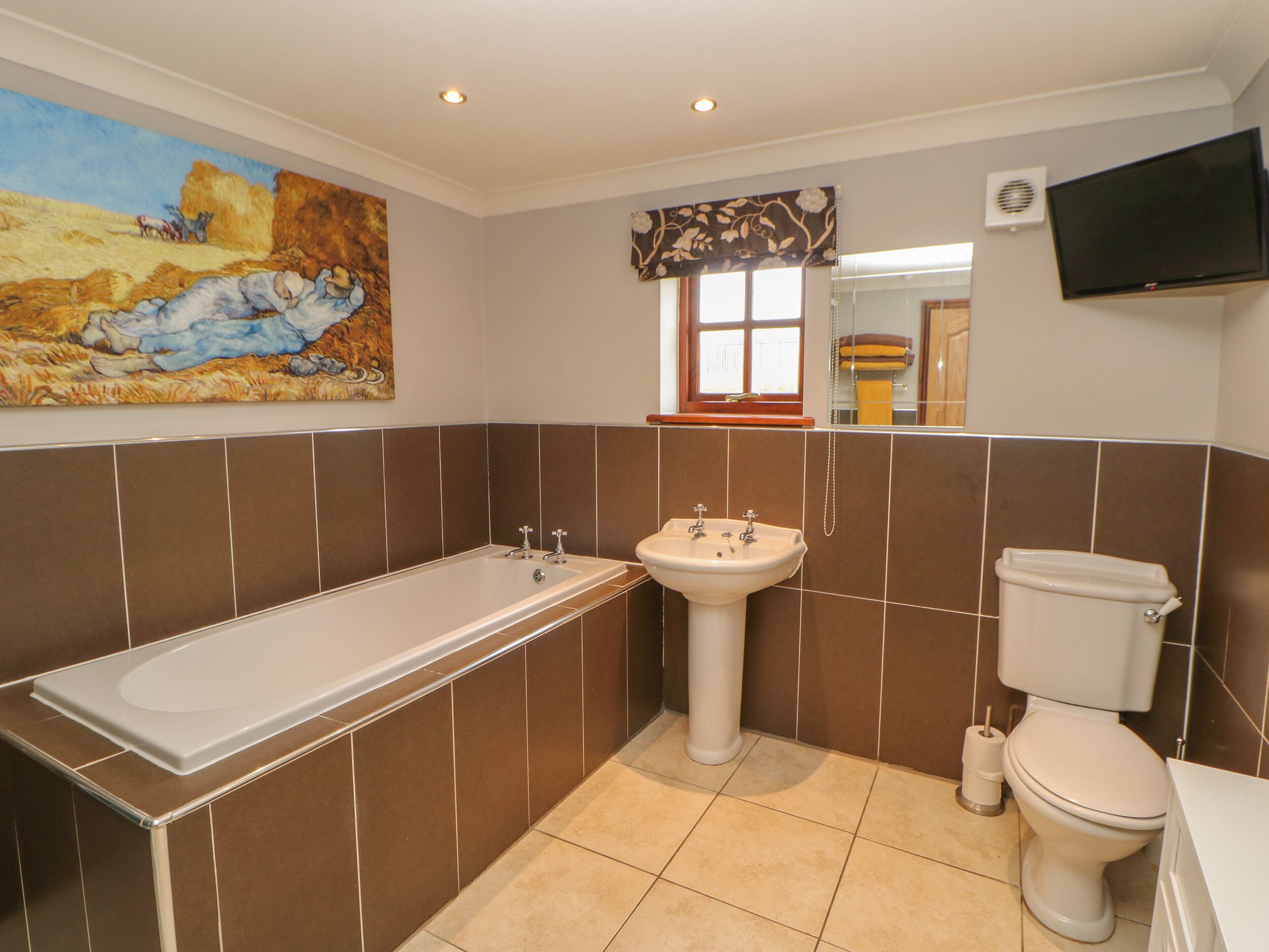 A bathroom with a bathtub, sink, and toilet.