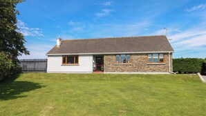 A two-story house with a stone facade and a tiled roof. - Oakland Cottage (Narberth)