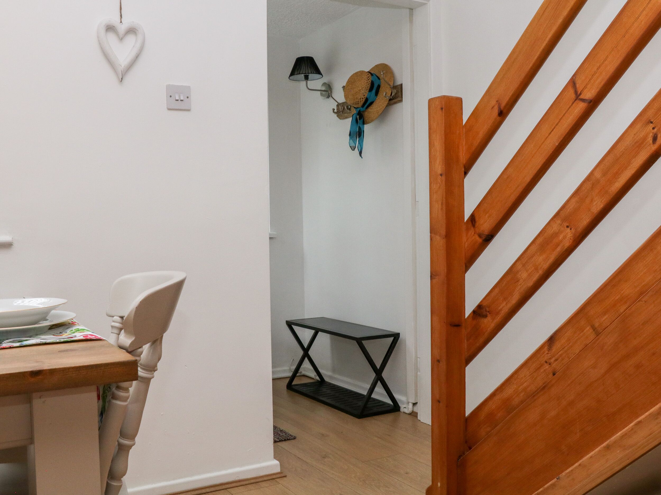 A staircase with wooden steps and a white wall.