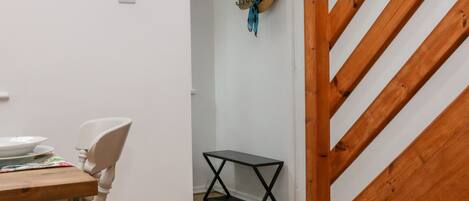 A staircase with wooden steps and a white wall.