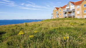 A coastal residential building with multiple balconies and a view of the sea. - Breakers (Newquay)