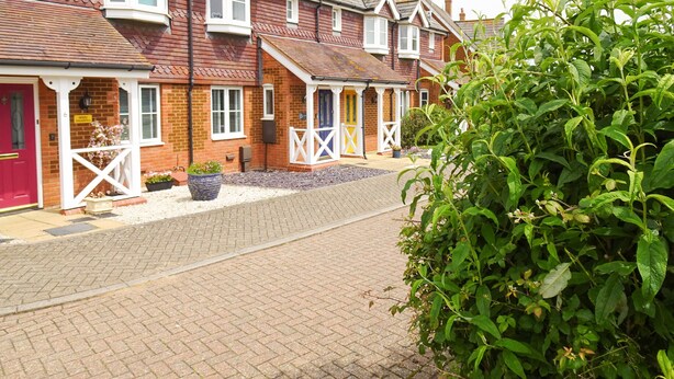 A row of terraced houses with distinct front doors and white railings. - 5 Styleman Road (Hunstanton)