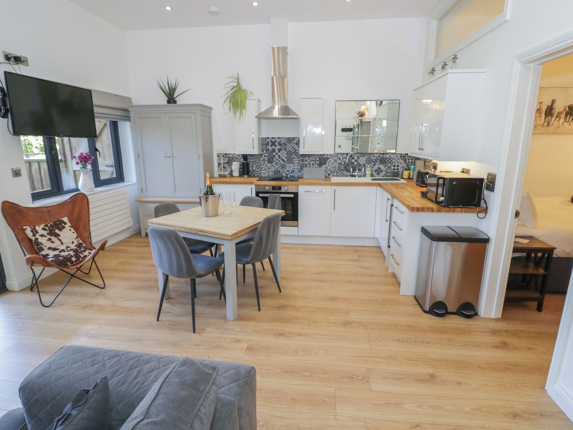Una cocina moderna con comedor, televisor y ventana con vistas.