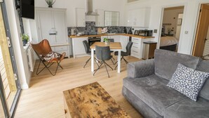 A modern apartment with a living room, dining area, and kitchen. - The Leat (Redditch)