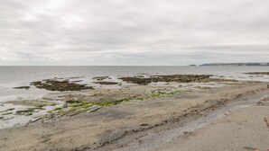 A coastal landscape with rocky formations and a sandy beach. - The Bolt Hole (Torpoint)