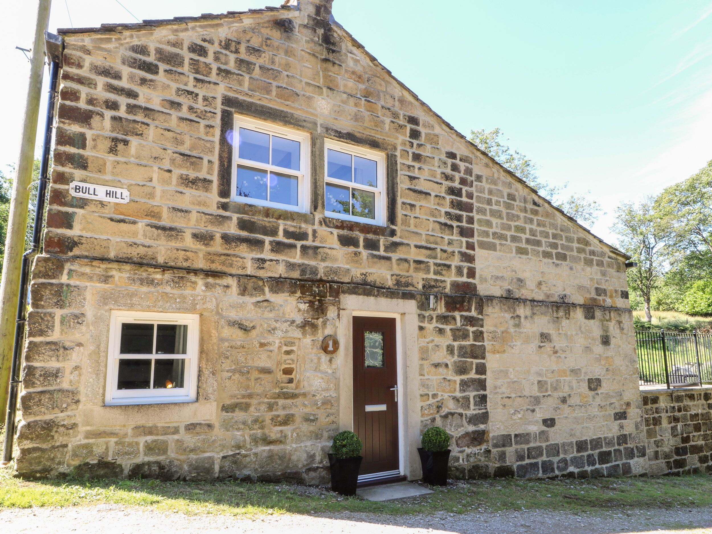 A stone building with a sign reading "BULL HILL".