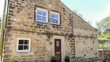 A stone building with a sign reading "BULL HILL".