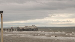A pier extending into the sea with a building at the end. - St. Heliers (Blackpool)